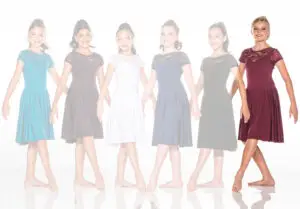 Six girls wearing colorful lace dresses stand in a row.