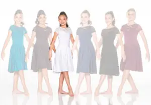Six girls wearing lace dresses, central dancer highlighted