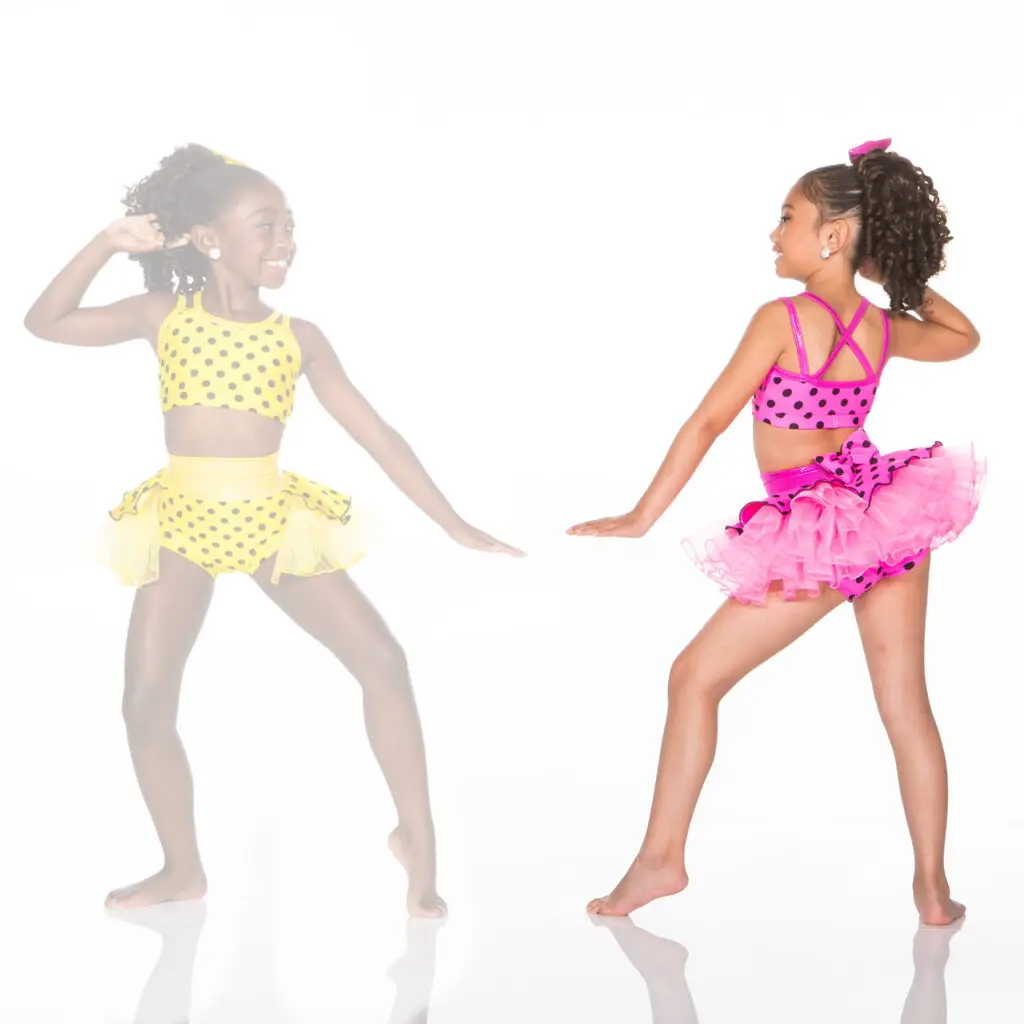 Two girls modeling colorful polka-dot dance costumes
