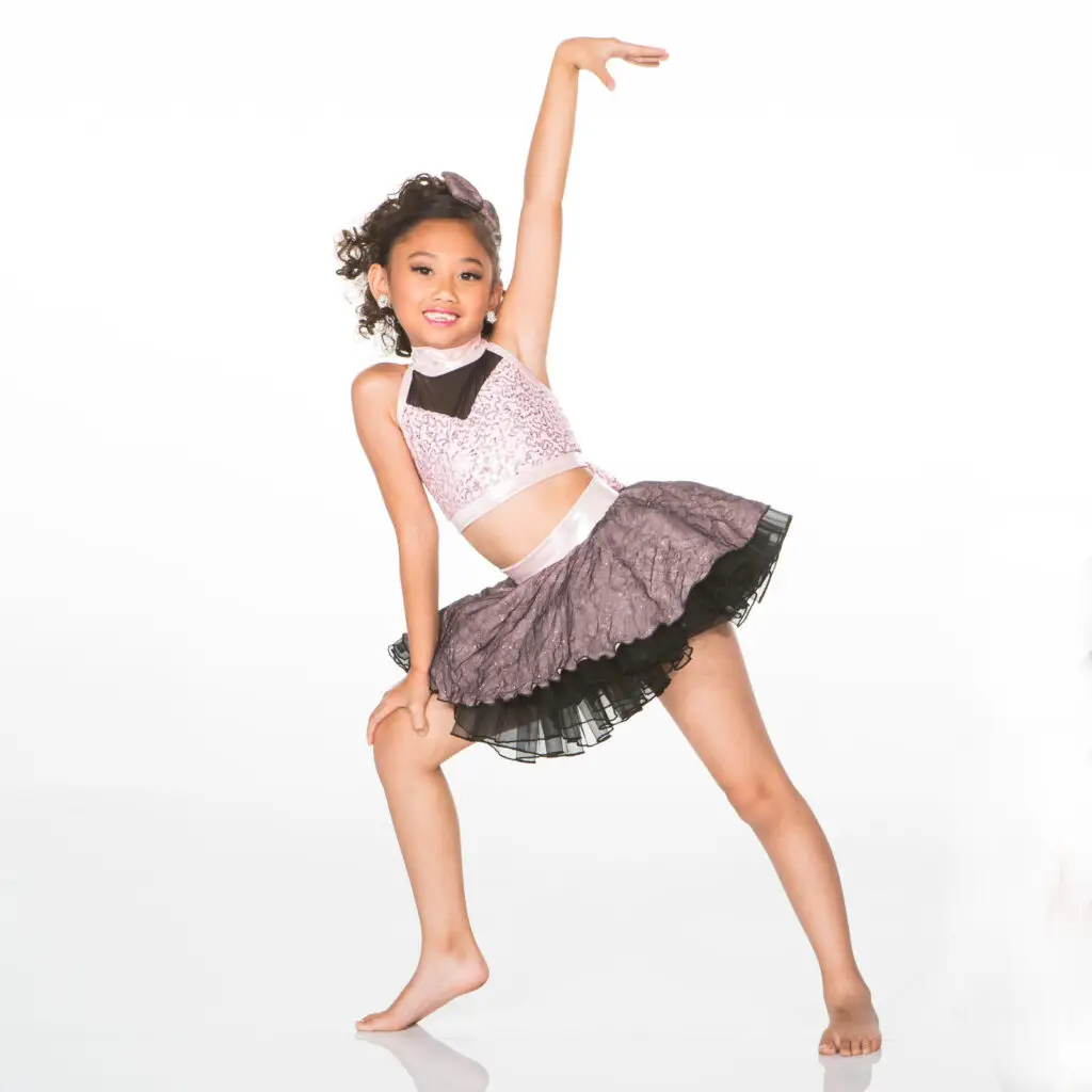 Young girl posing in a sparkly dance costume