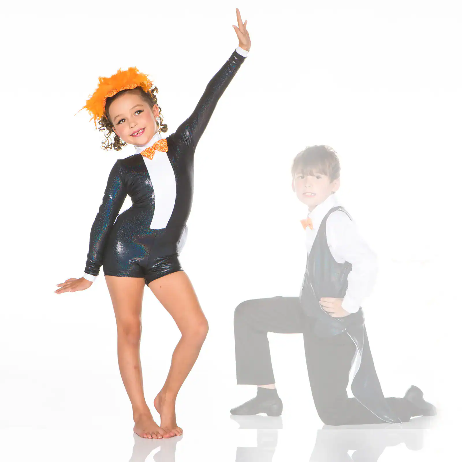 Two children in black-and-orange dance costumes posing