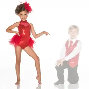 Young dancer in red costume points toward kneeling boy.