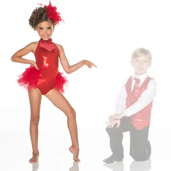 Young dancer in red costume points toward kneeling boy.