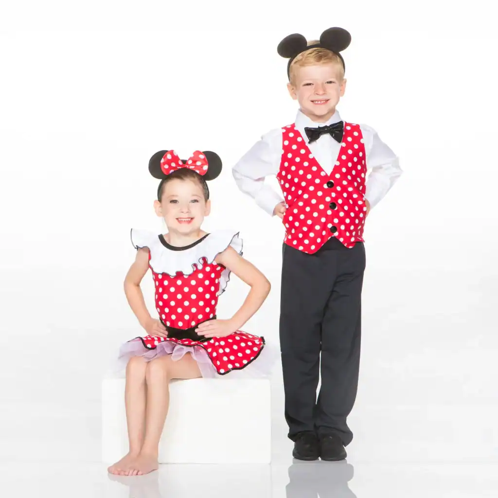 Two children wearing mouse-themed red polka-dot costumes