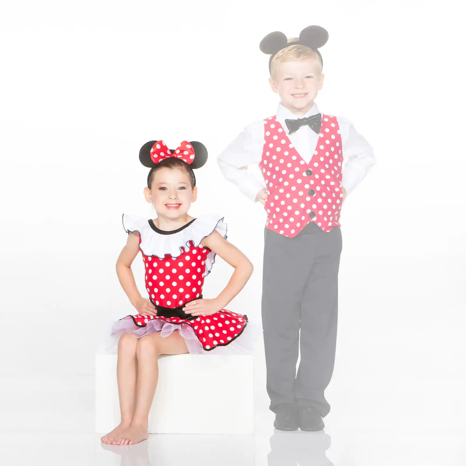 Two children wearing Mickey and Minnie-inspired costumes
