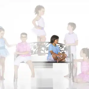 Six children in gingham outfits pose around a decorative bench.