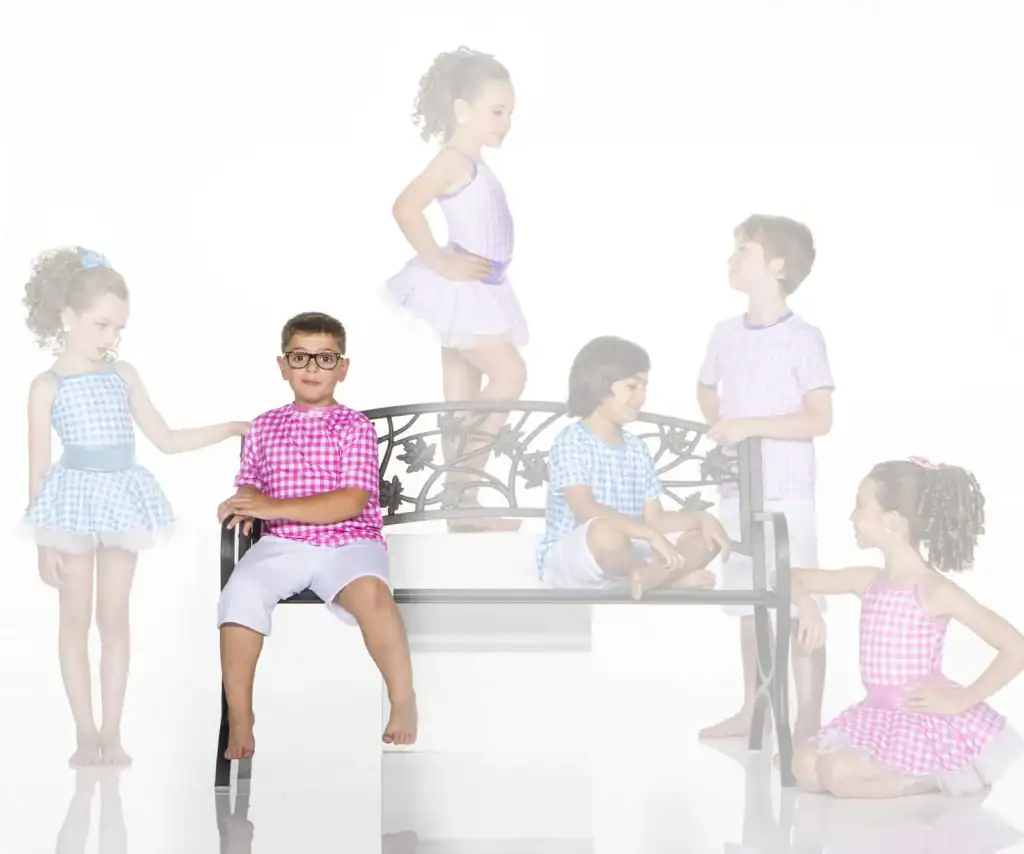 Children in colorful gingham outfits around a decorative bench