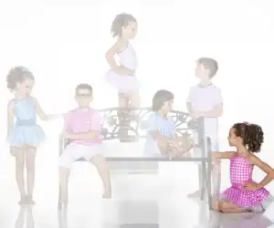 Six children in colorful gingham outfits around a decorative bench