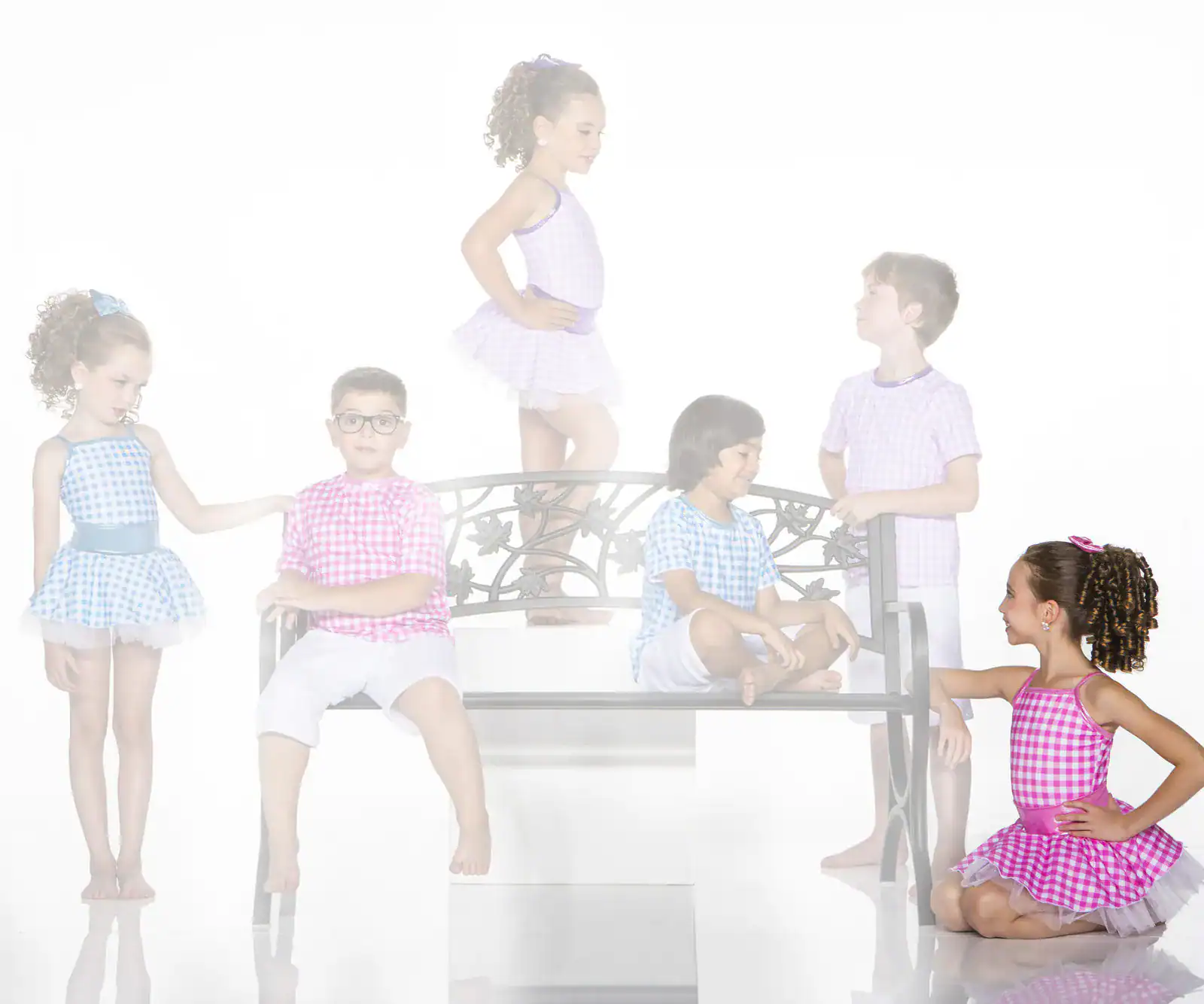 Six children in colorful gingham outfits around a decorative bench