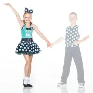 Two children in matching polka-dot dance costumes holding hands
