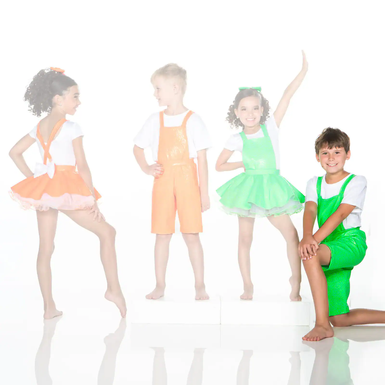 Four children modeling colorful dance costumes on white background
