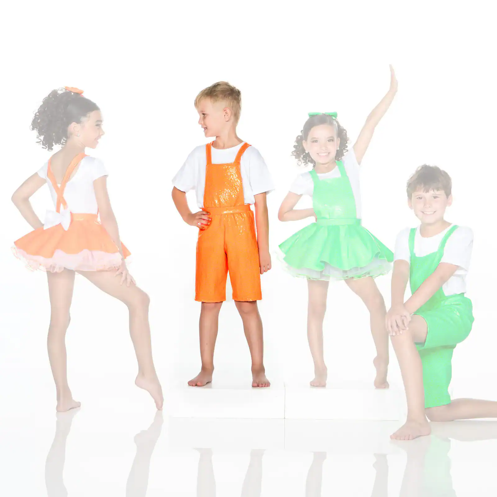Four children modeling colorful dance costumes against white background