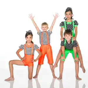 Four children posing in colorful polka-dot and striped costumes