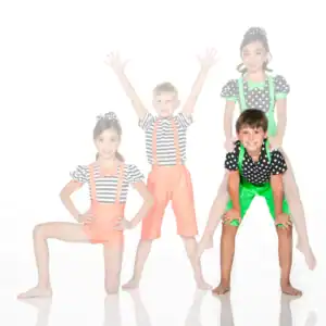 Four children in colorful clown costumes posing together