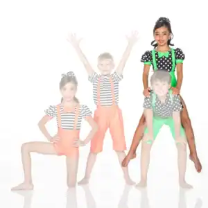 Four children in colorful polka-dot and striped costumes posing