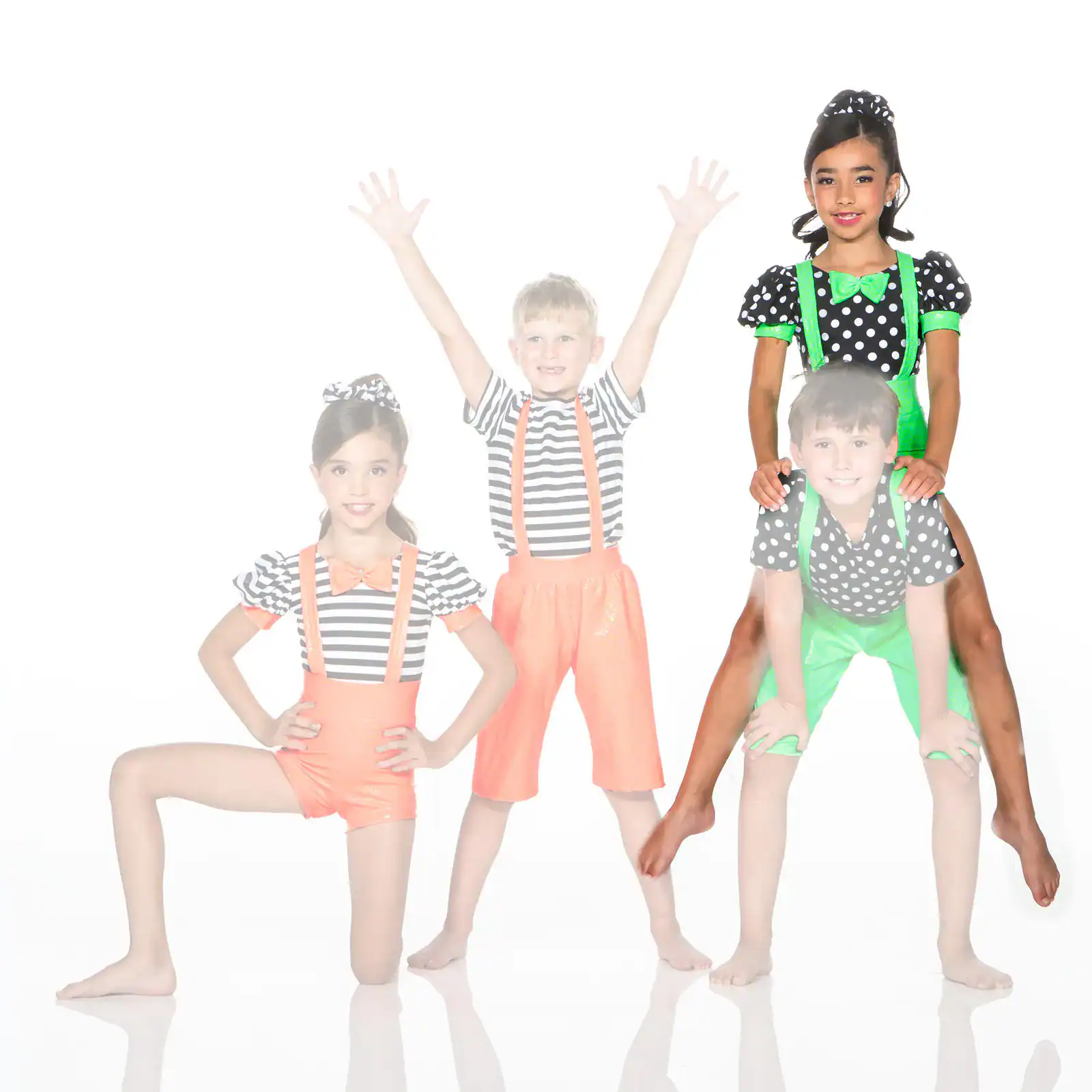 Four children in colorful polka-dot and striped costumes posing