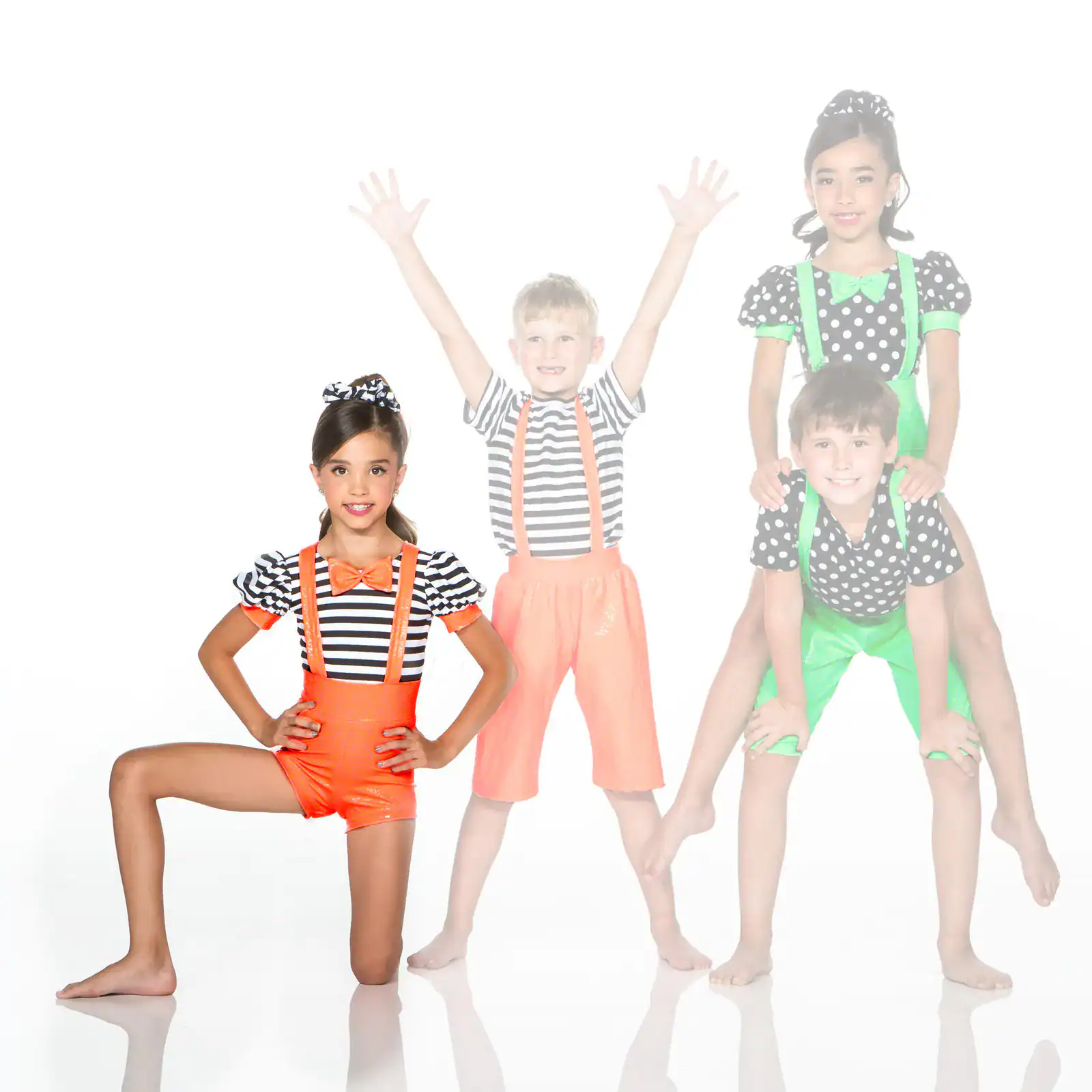 Four children in colorful striped and polka-dot costumes posing