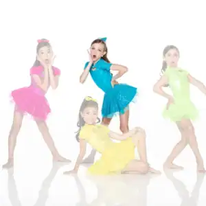 Four young dancers in colorful costumes posing on white background
