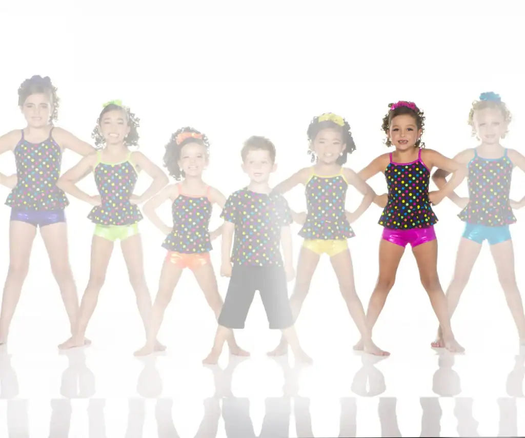 Seven children in colorful polka-dot dance costumes posing