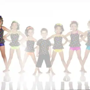 Children posing in colorful polka-dot dance costumes