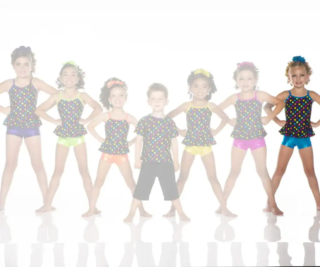Seven young dancers in colorful polka-dot costumes pose together.