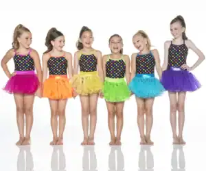 Six young dancers in colorful polka-dot costumes and tutus