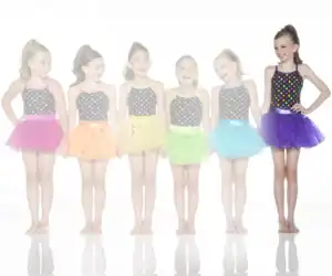Six girls wearing colorful polka-dot dance costumes and tutus