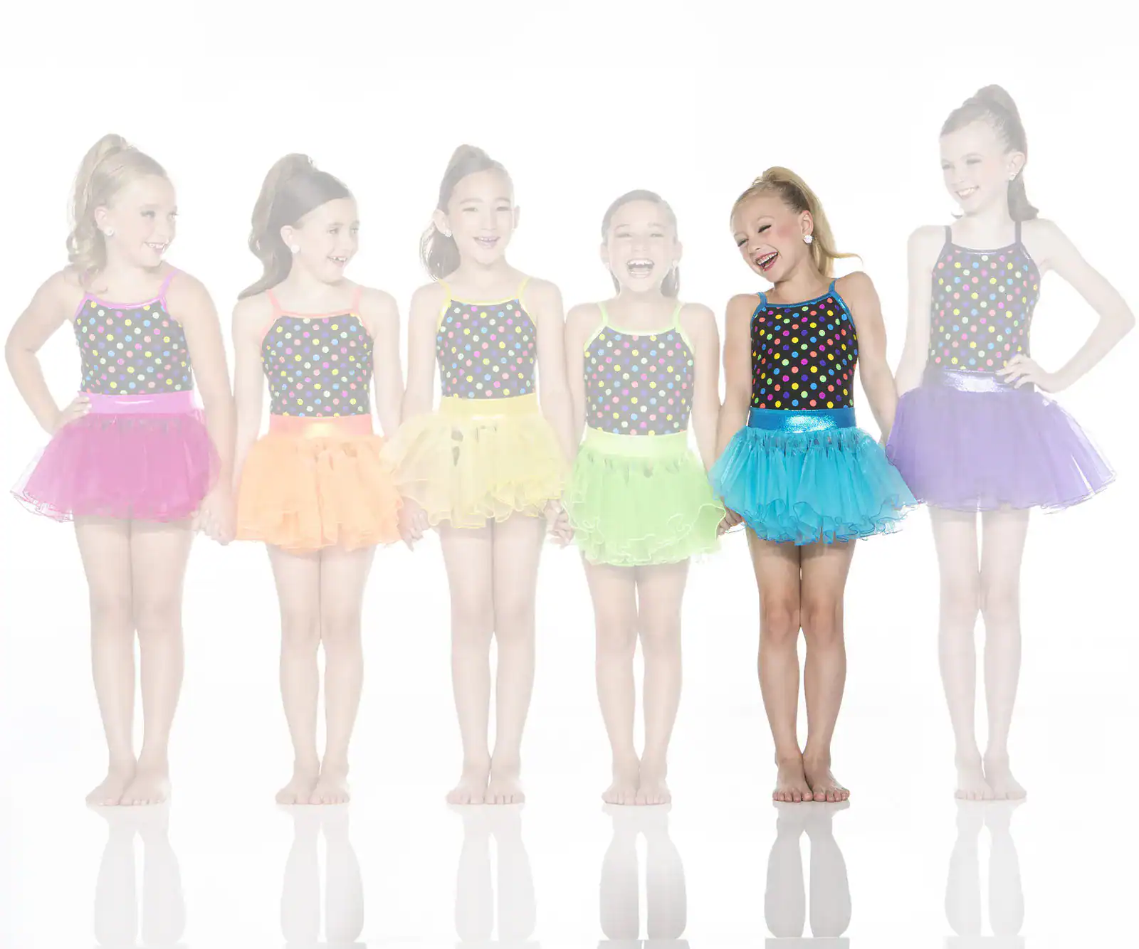 Six young dancers wearing colorful polka-dot costumes and tutus