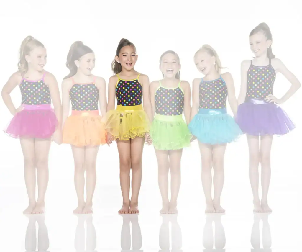 Six girls wearing colorful polka-dot dance costumes and tutus