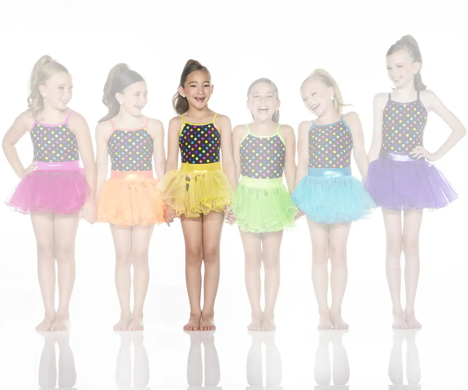 Six girls wearing colorful polka-dot dance costumes and tutus