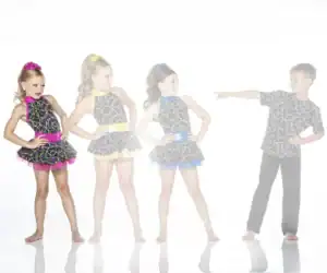 Four children in colorful dance costumes posing together