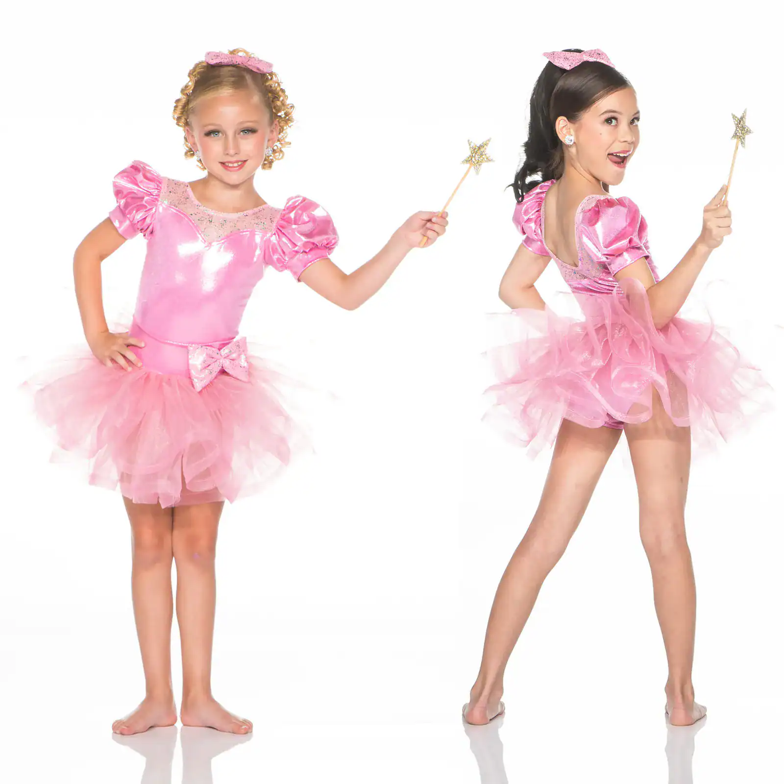 Two girls wearing pink fairy costumes and holding star wands