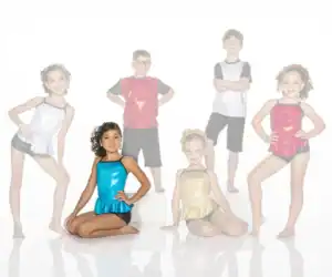 Six children wearing colorful dance costumes pose in a studio.