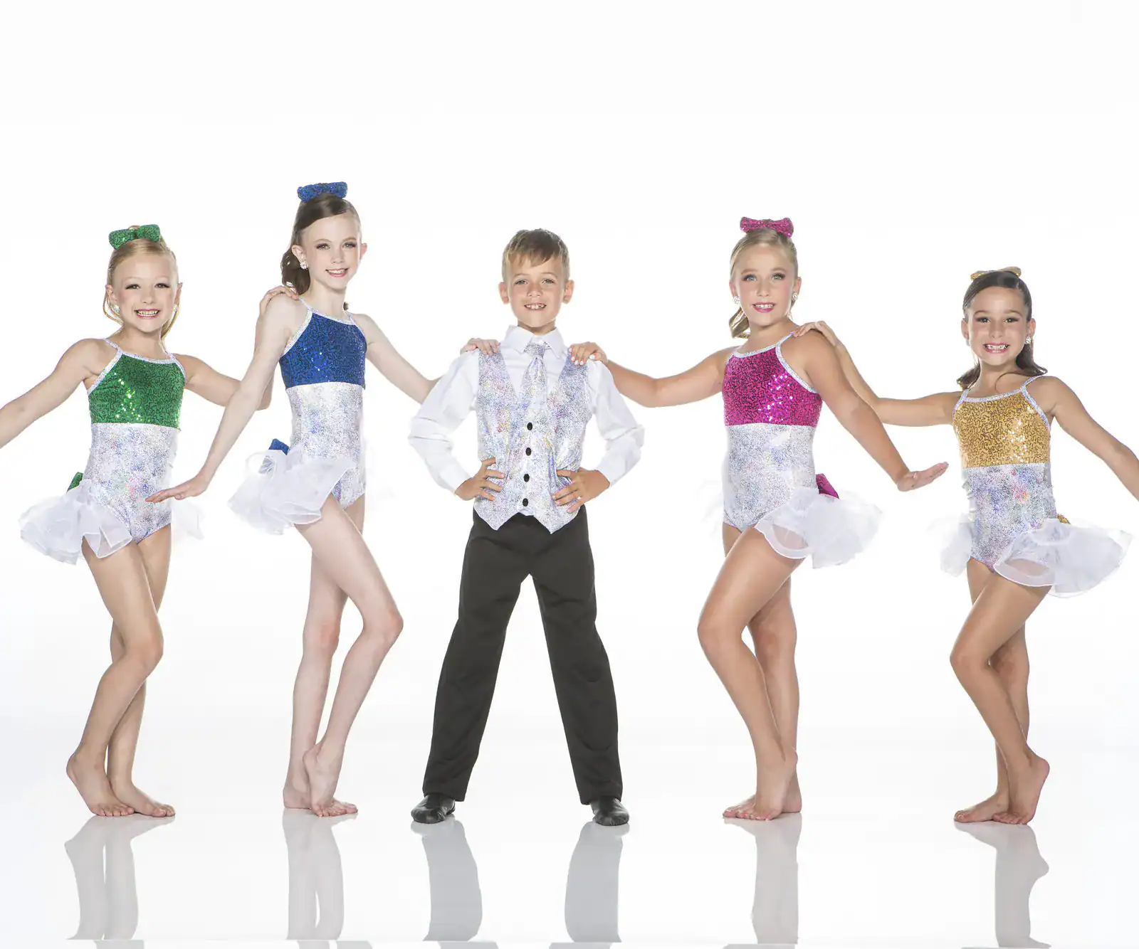 Five young dancers pose in colorful sequined costumes.