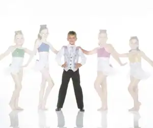 Five young dancers pose in colorful costumes on white background.
