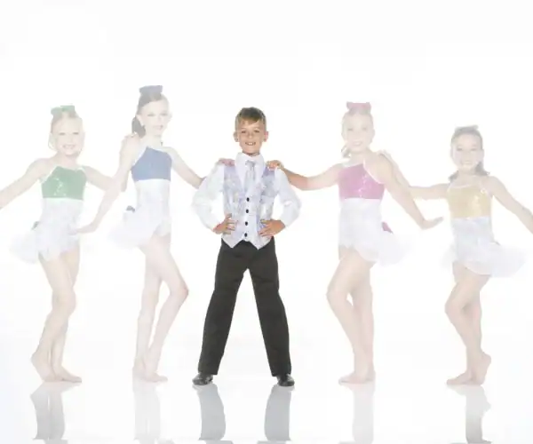 Five young dancers pose in colorful costumes on white background.