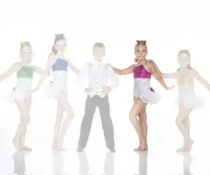 Five young dancers in colorful costumes posing together