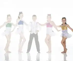 Five young dancers in colorful costumes posing together