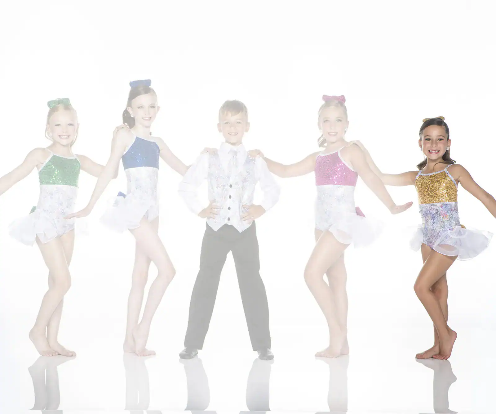Five young dancers in colorful costumes posing together