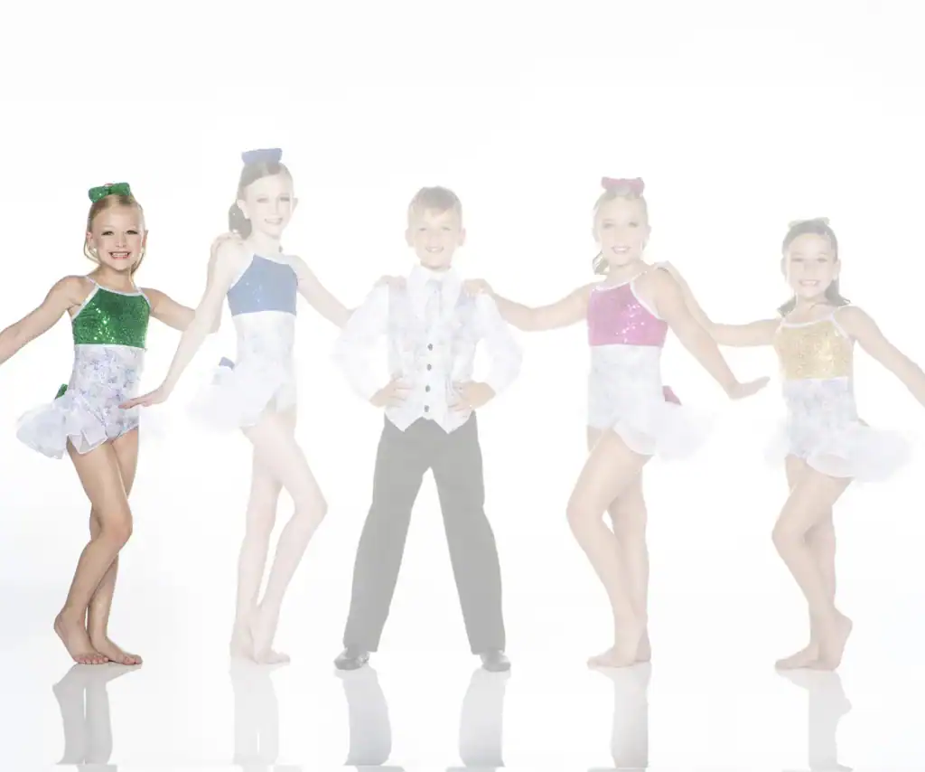 Five young dancers in sparkling costumes pose together.