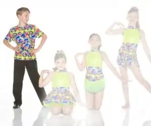 Four young dancers pose in colorful, patterned dance costumes.