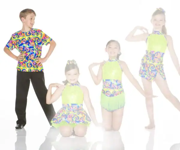 Four young dancers pose in colorful, patterned dance costumes.