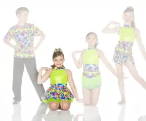 Four young dancers in colorful matching costumes posing together