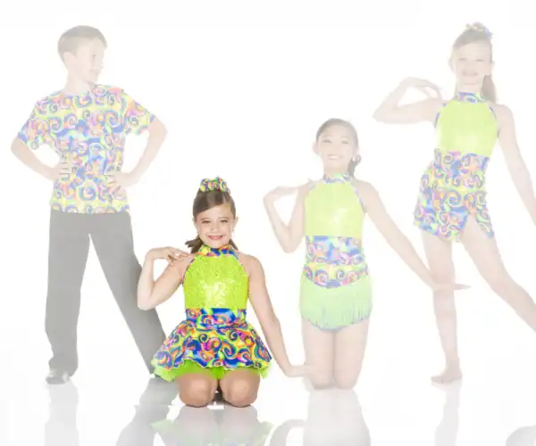 Four young dancers in colorful matching costumes posing together
