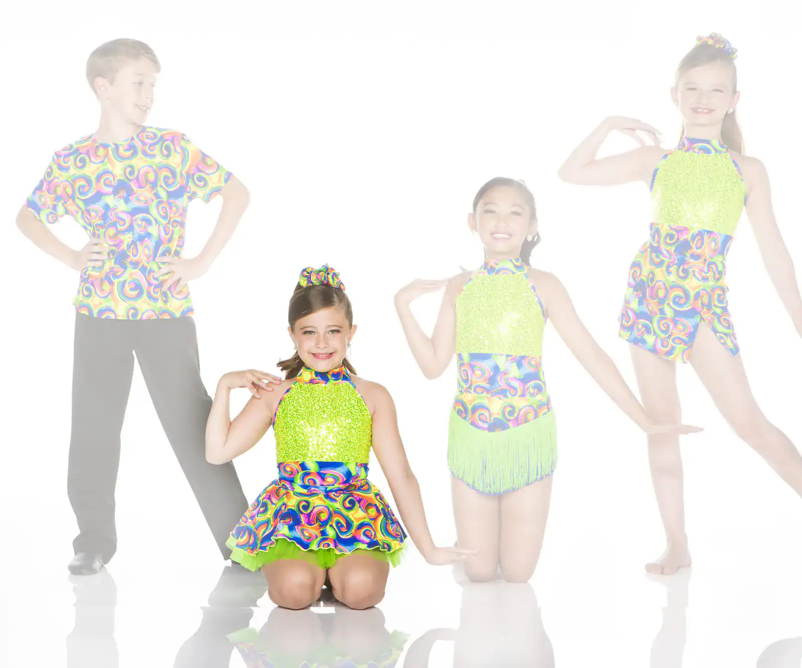 Four young dancers in colorful matching costumes posing together