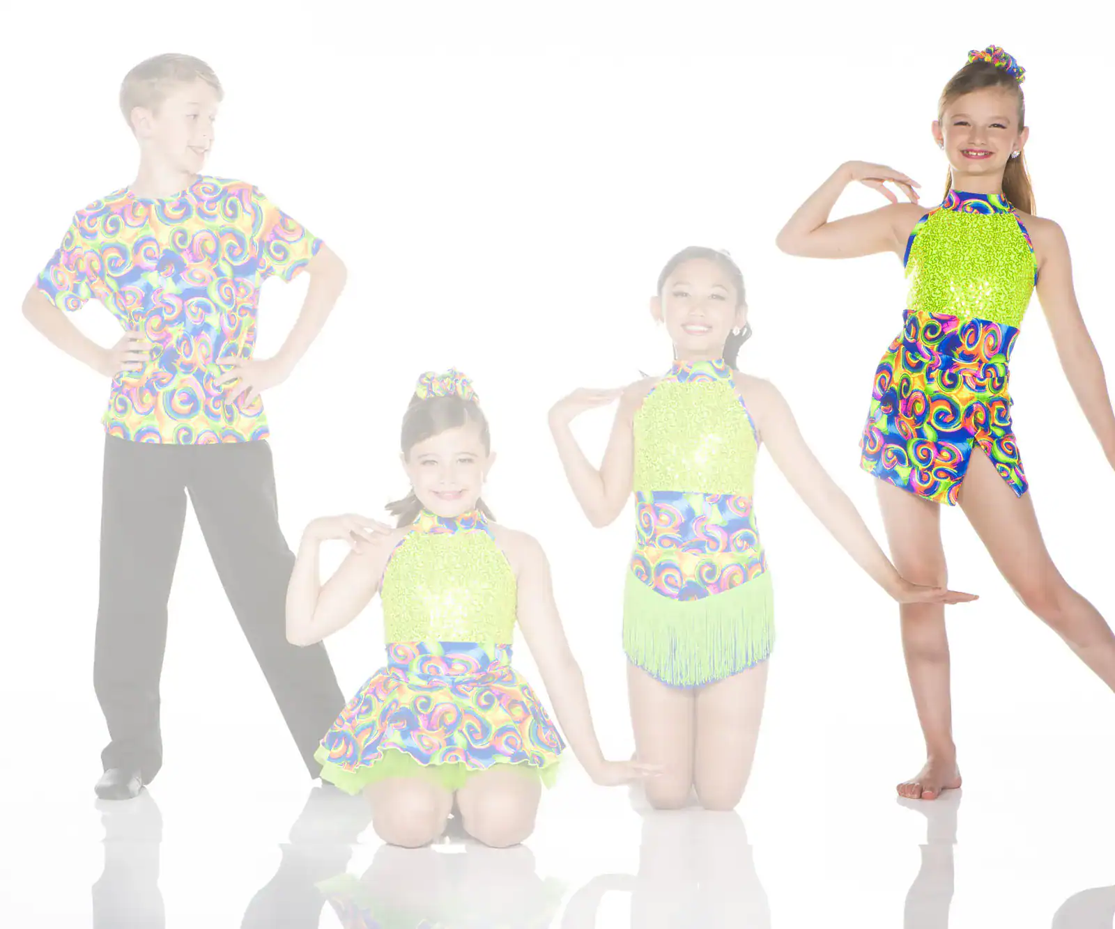 Four children pose in colorful dance costumes on white background.