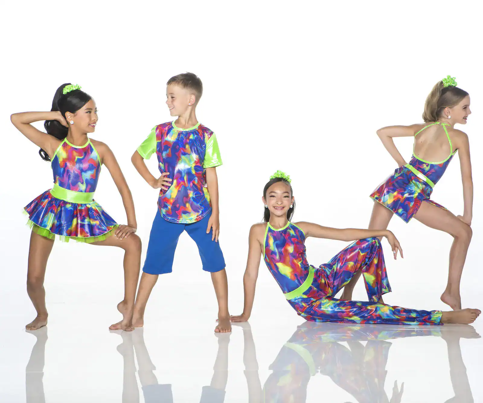Children modeling colorful neon dance costumes on white background