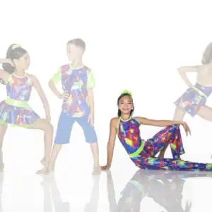 Children modeling colorful neon dance costumes against a white background