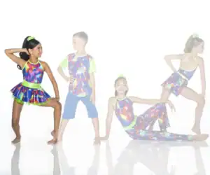 Four children pose in colorful neon dance costumes.