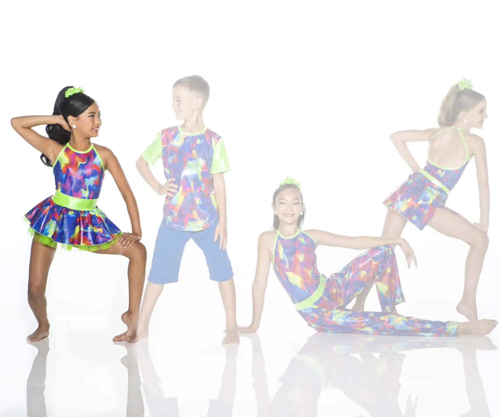 Four children pose in colorful neon dance costumes.